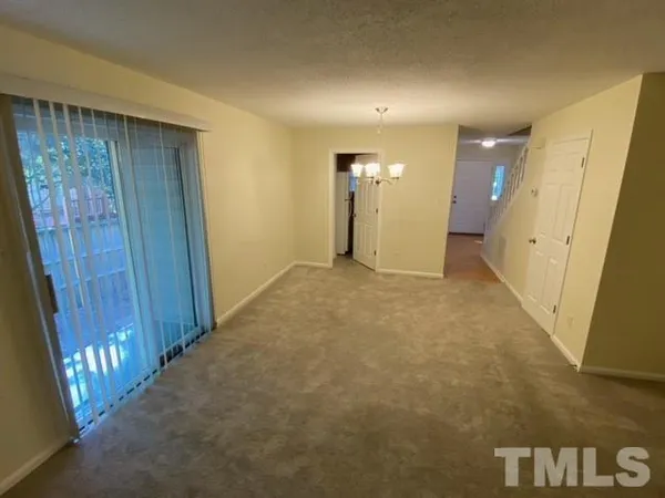 a view of an empty room with wooden door