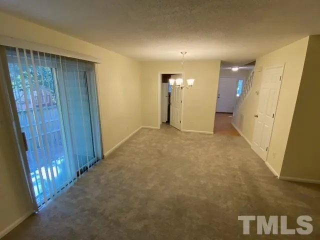 a view of an empty room with wooden door