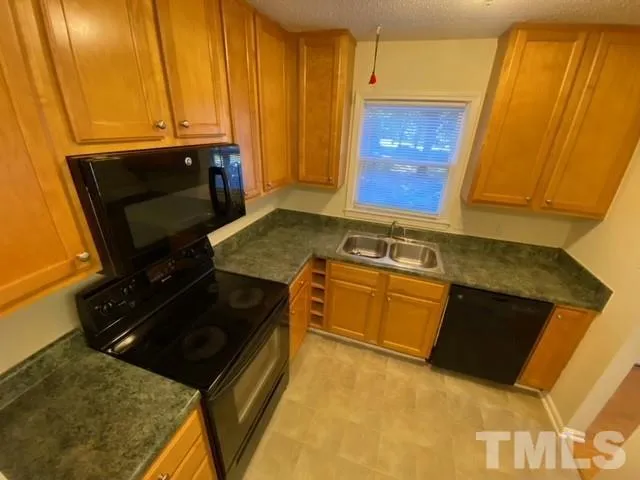 a kitchen with a stove and a microwave