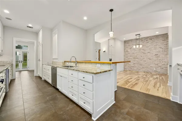 a kitchen with a sink window and cabinets