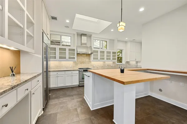 a kitchen with granite countertop a sink and a stove