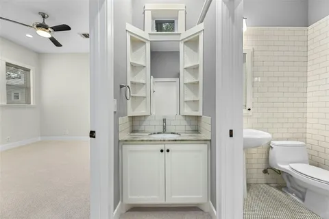 a bathroom with a granite countertop sink and a mirror