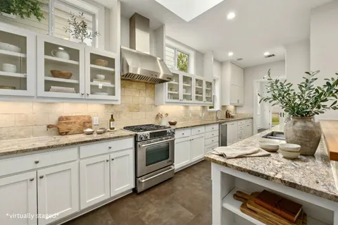 a kitchen with a sink stove and cabinets