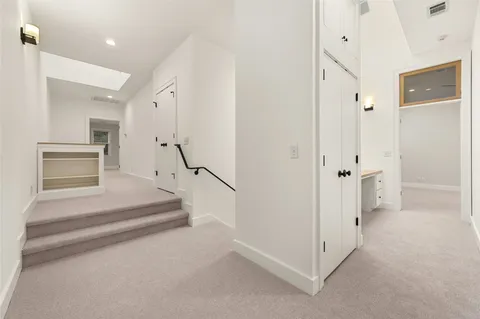 a view of an empty room with a ceiling fan and window