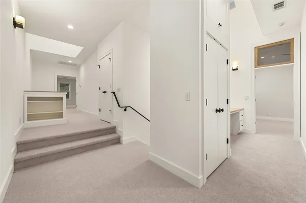 a view of an empty room with a ceiling fan and window