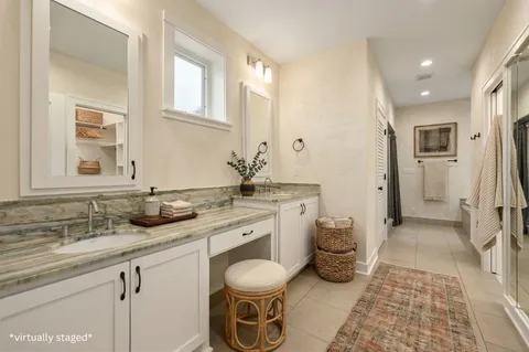 a spacious bathroom with a granite countertop sink and a mirror