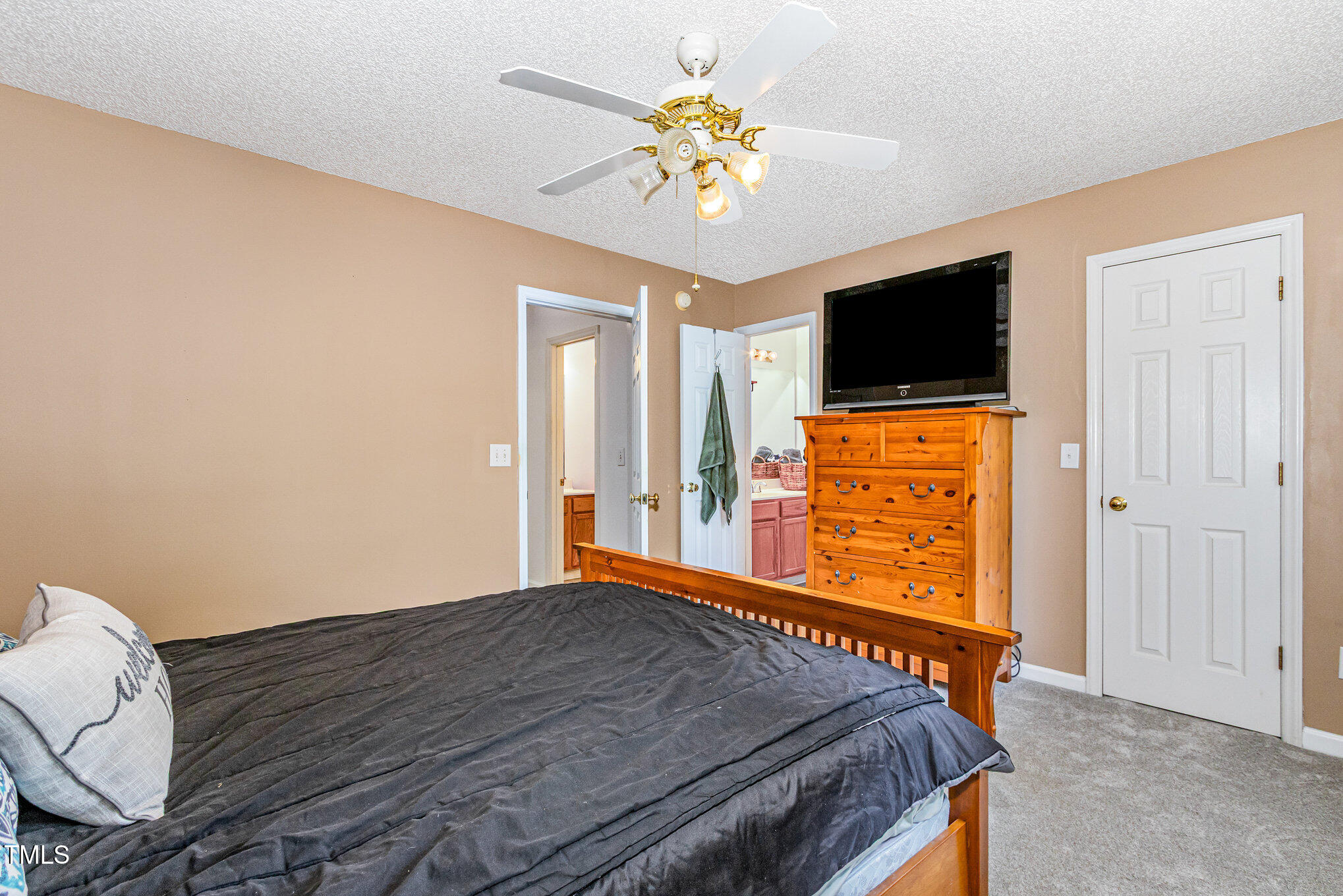7329 Bonnie Ridge Court Raleigh, NC 27615 - Photo 14 of 17 a bedroom with a bed and a flat screen tv