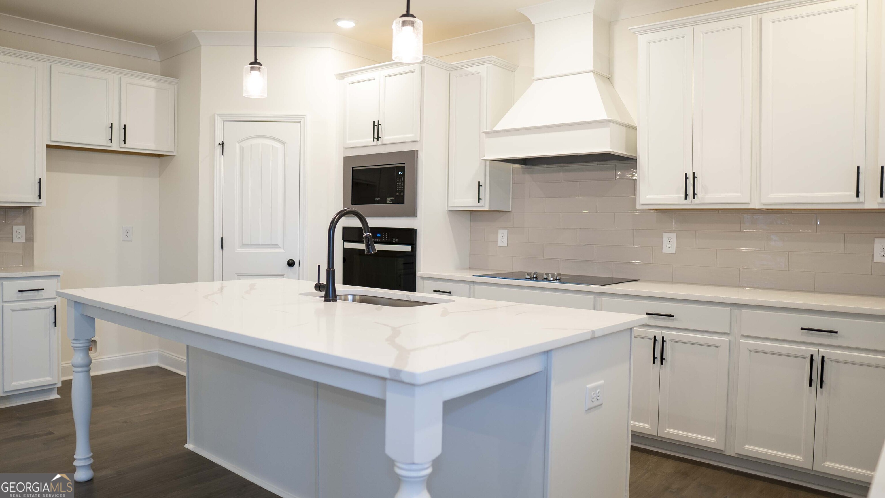 604 Beaver Court Perry, GA 31069 - Photo 13 of 40 a kitchen with white cabinets and refrigerator