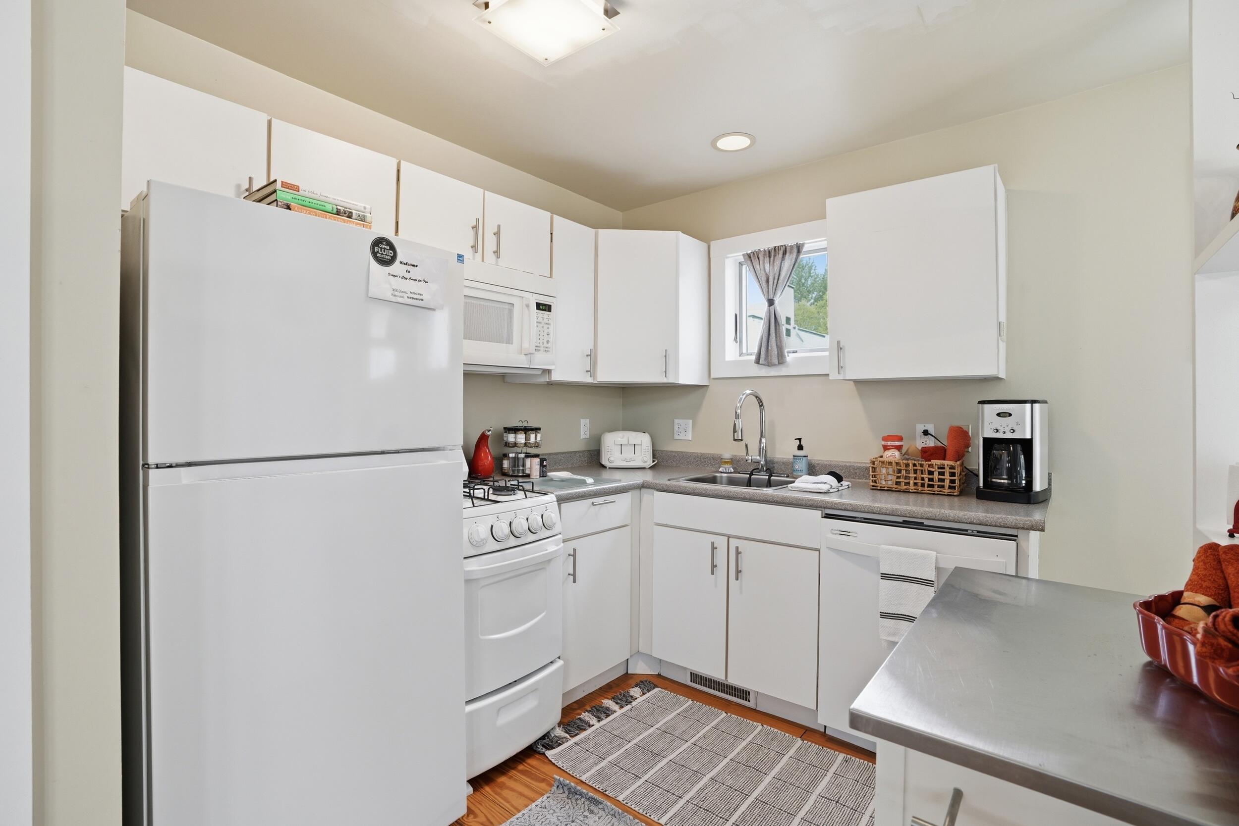 10 Tryon Farm Lane, Unit F10 Michigan City, IN 46360 - Photo 8 of 32 a kitchen with a sink a refrigerator and cabinets