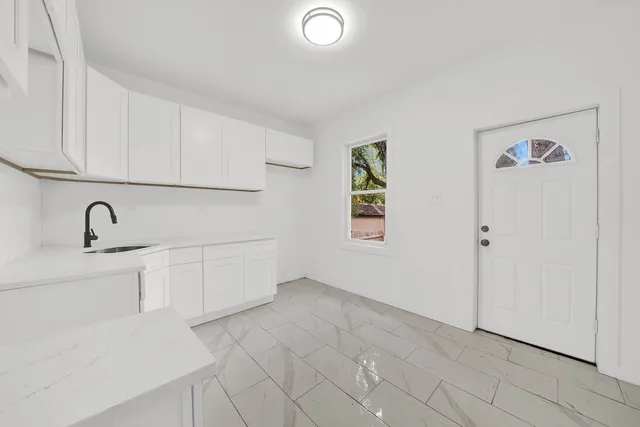 a view of a kitchen with electric appliances