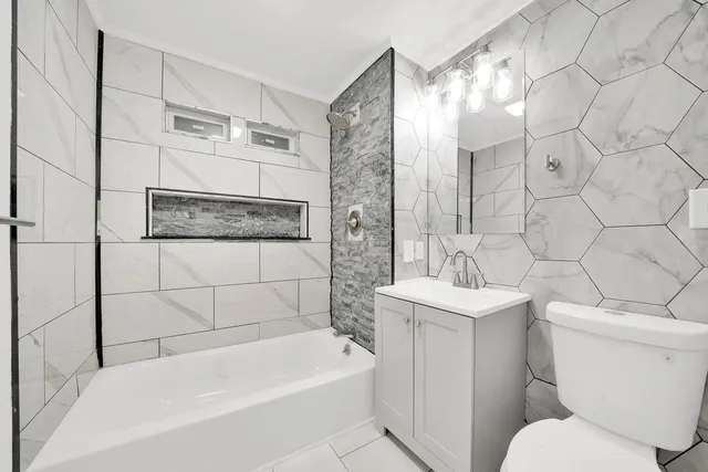 a bathroom with a toilet a sink and bathtub