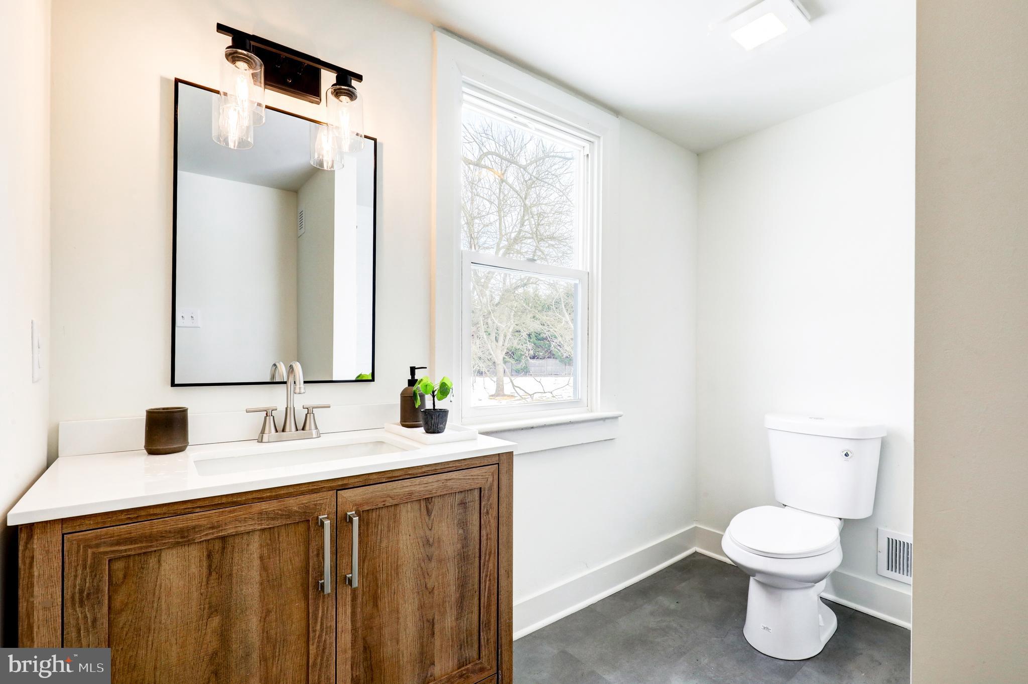 1419 Snyder Corner Road Red Lion, PA 17356 - Photo 22 of 30 a bathroom with a toilet sink and mirror