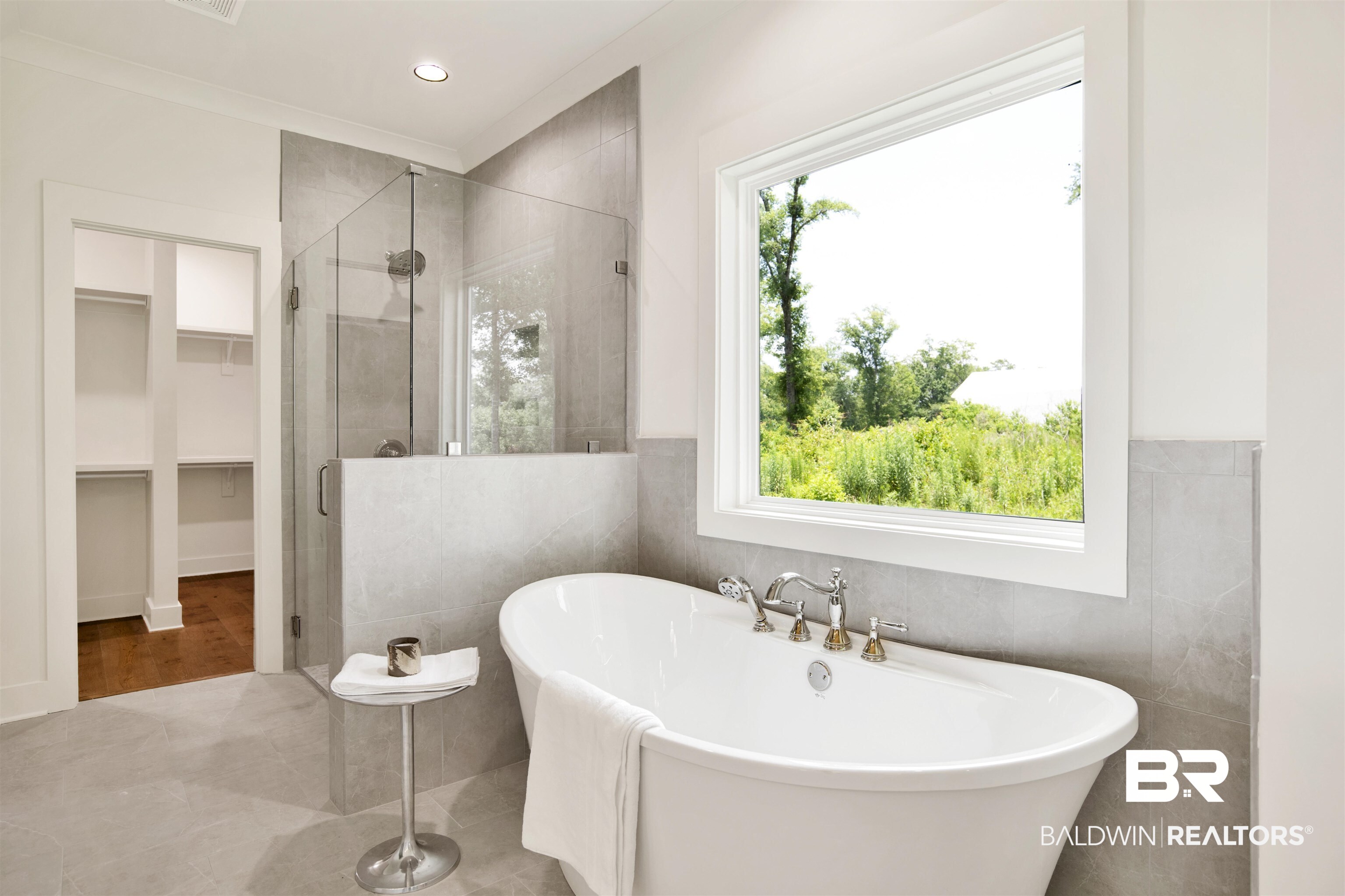 9275 Clarke Ridge Road Foley, AL 36535 - Photo 25 of 43 Bathroom with a stall shower, tile walls, a soaking tub, a spacious closet, and recessed lighting