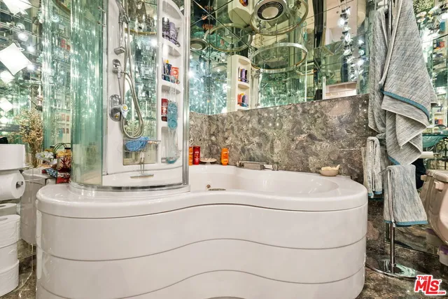 a white bath tub sitting next to a white sink