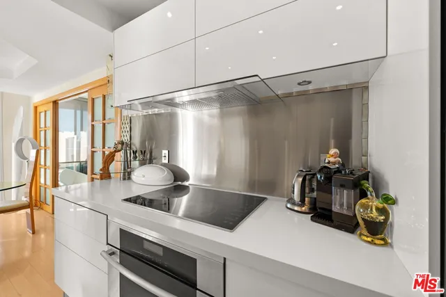 a kitchen with a sink and a stove top oven