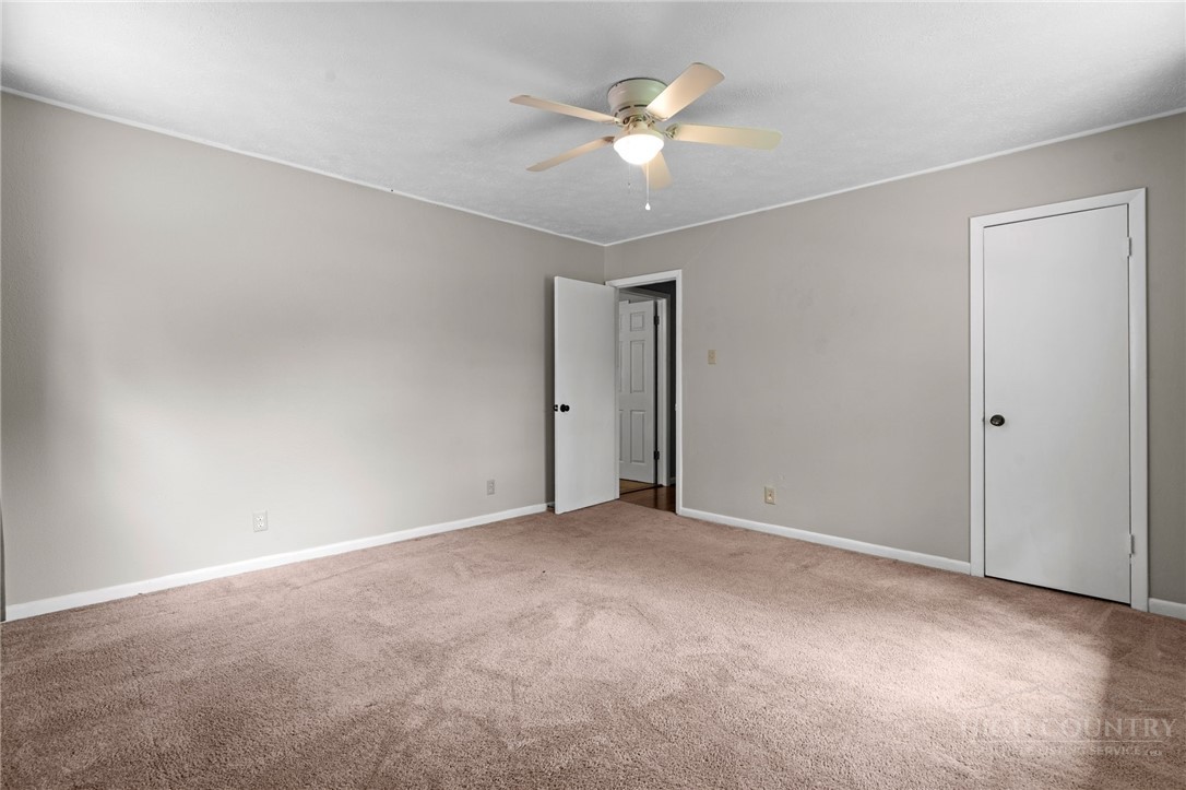 2345 Watauga River Road Sugar Grove, NC 28679 - Photo 21 of 50 an empty room with a ceiling fan and a window