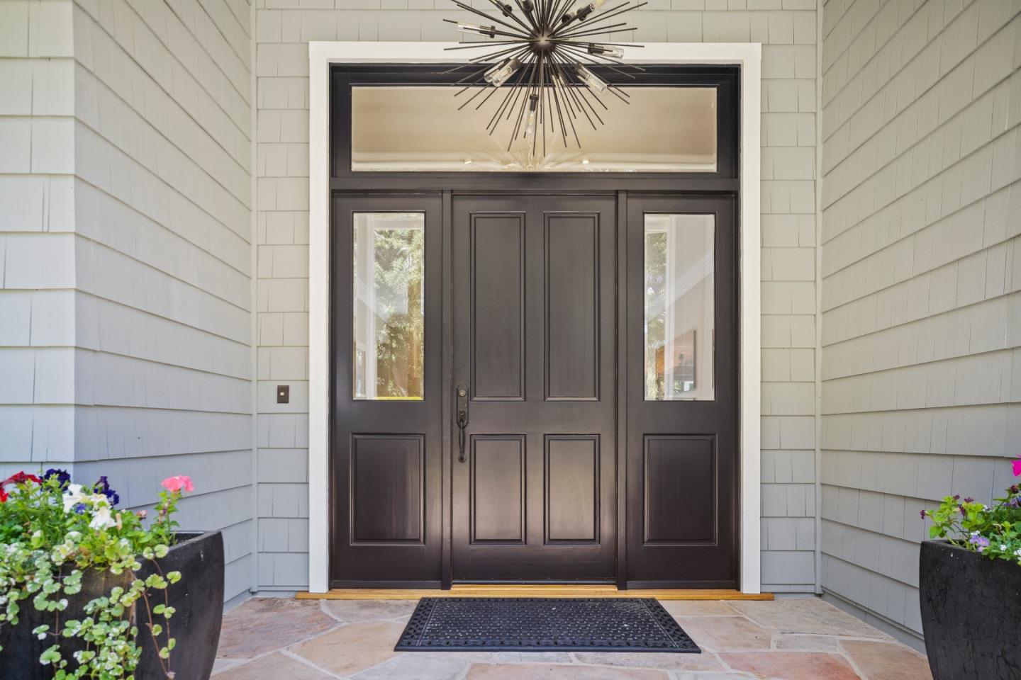 2823 Congress Road Pebble Beach, CA 93953 - Photo 2 of 49 a front view of a house with a potted plant