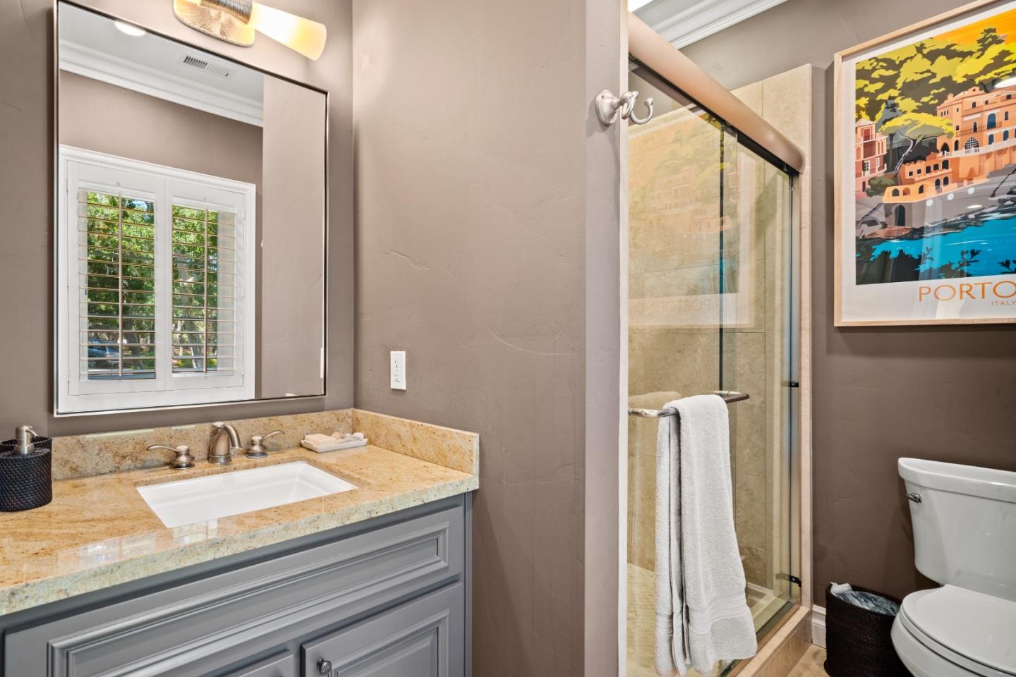 2823 Congress Road Pebble Beach, CA 93953 - Photo 25 of 49 a bathroom with a granite countertop sink and a mirror
