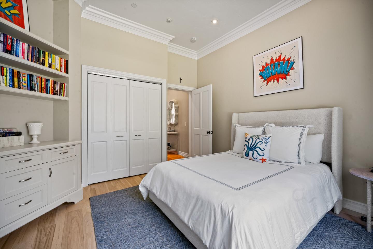 2823 Congress Road Pebble Beach, CA 93953 - Photo 31 of 49 a bedroom with a bed and a book shelf