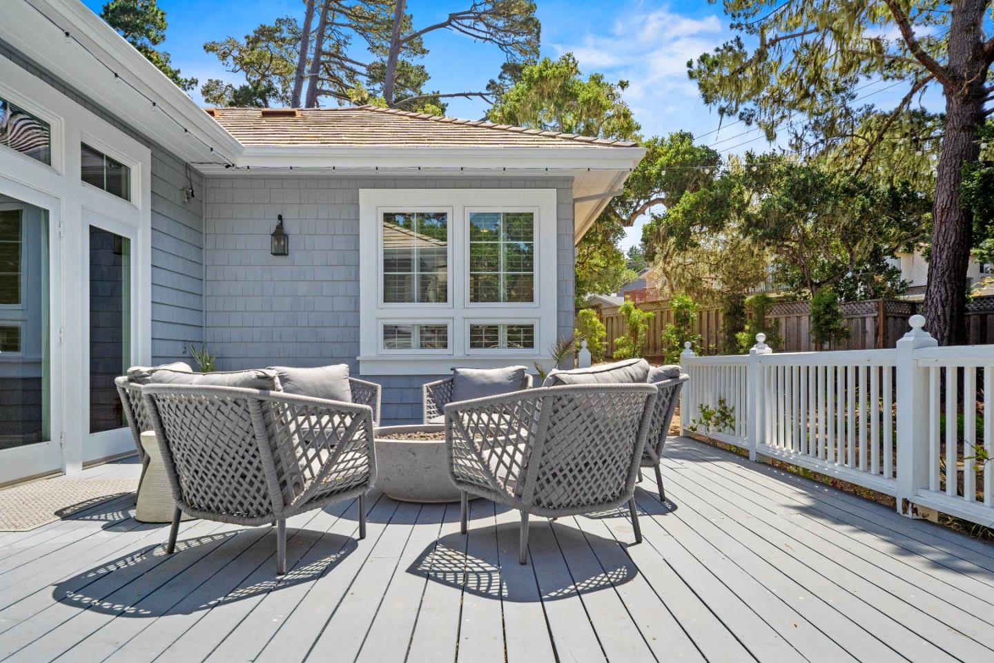2823 Congress Road Pebble Beach, CA 93953 - Photo 43 of 49 a view of a deck with table and chairs and wooden floor