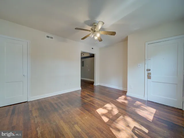 a view of an empty room and wooden floor