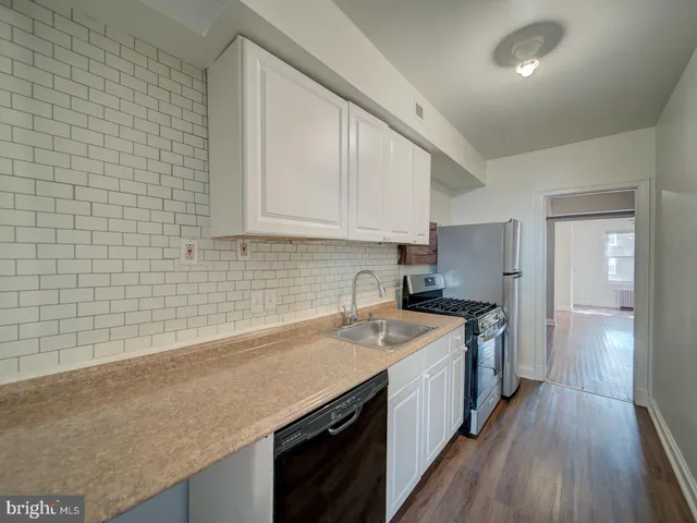 a kitchen with a sink stove and cabinets