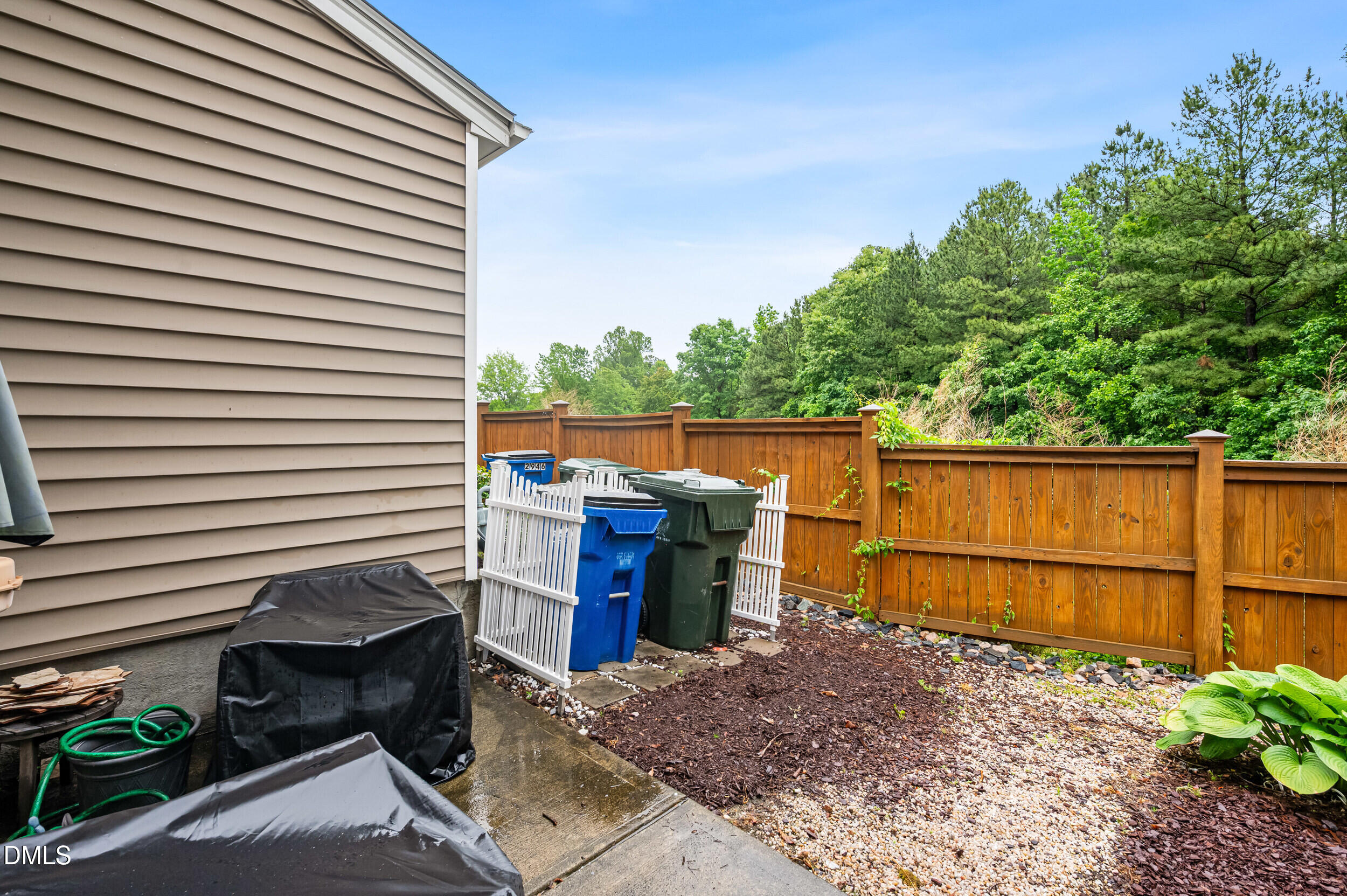2944 Casona Way Raleigh, NC 27616 - Photo 20 of 24 a backyard of a house with lake view and a potted plant