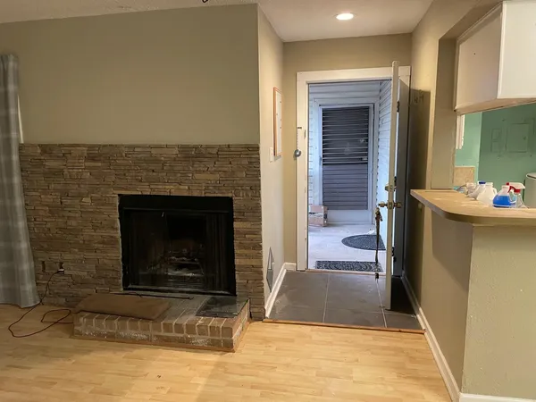 a view of an empty room and fire place