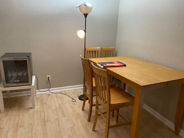 a view of a dining room with furniture and wooden floor