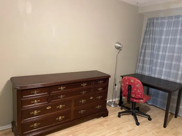 a room with a dresser and a chair