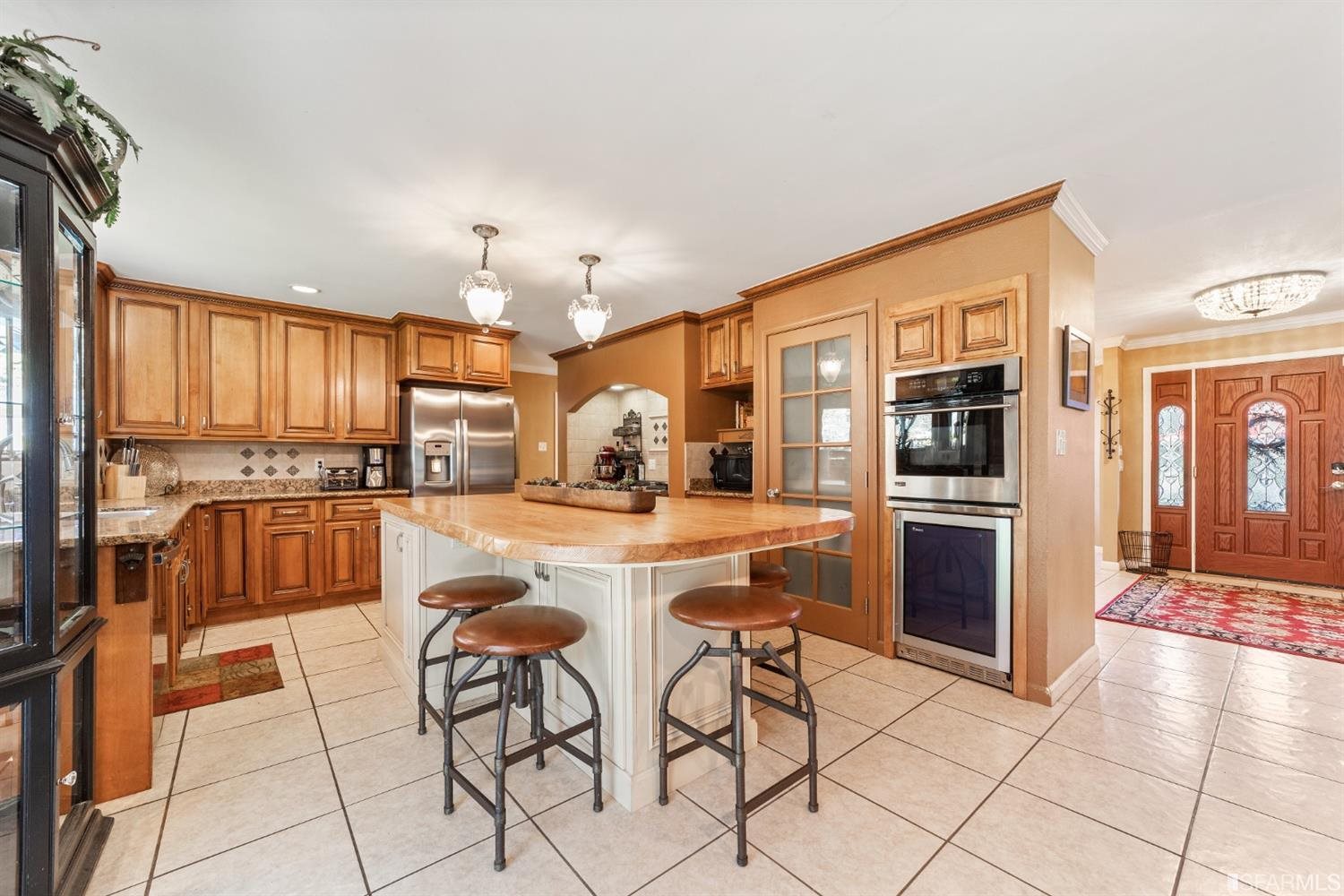 4912 John Muir Road Martinez, CA 94553 - Photo 12 of 59 a kitchen with stainless steel appliances kitchen island granite countertop a refrigerator and cabinets
