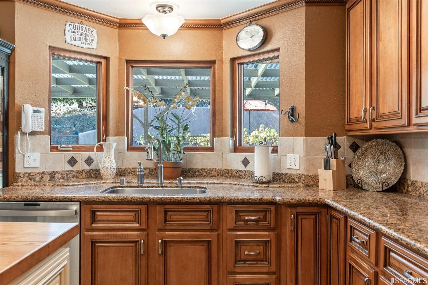 4912 John Muir Road Martinez, CA 94553 - Photo 14 of 59 a kitchen with granite countertop a sink and a window