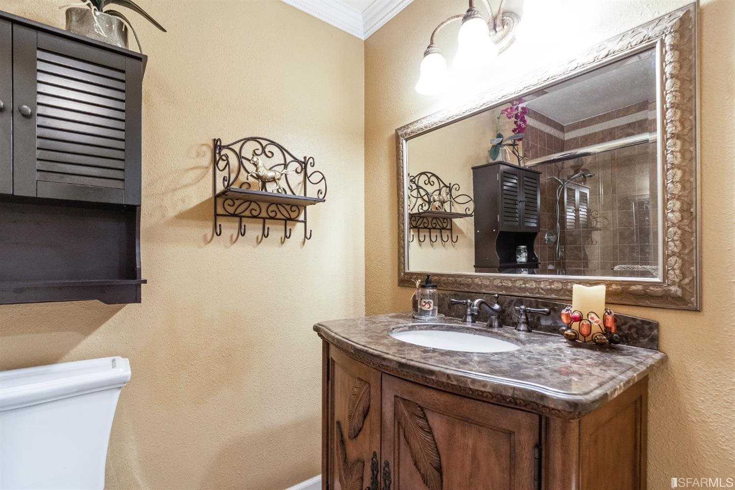 4912 John Muir Road Martinez, CA 94553 - Photo 24 of 59 a bathroom with a granite countertop sink and a mirror