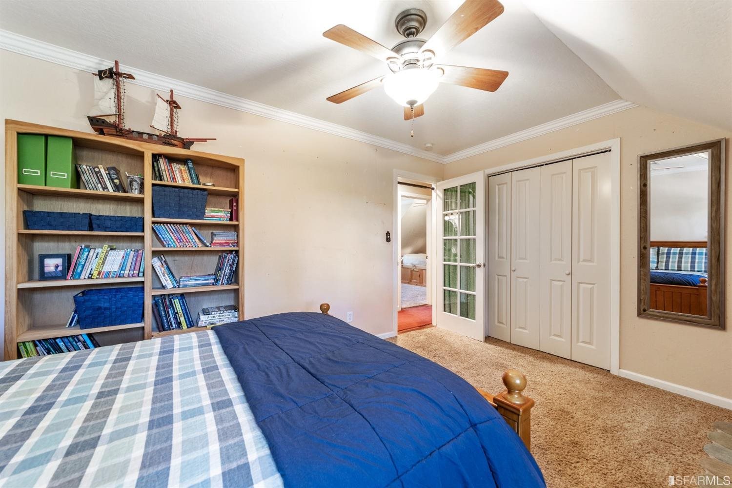 4912 John Muir Road Martinez, CA 94553 - Photo 36 of 59 a bedroom with a bed a book shelf and a window