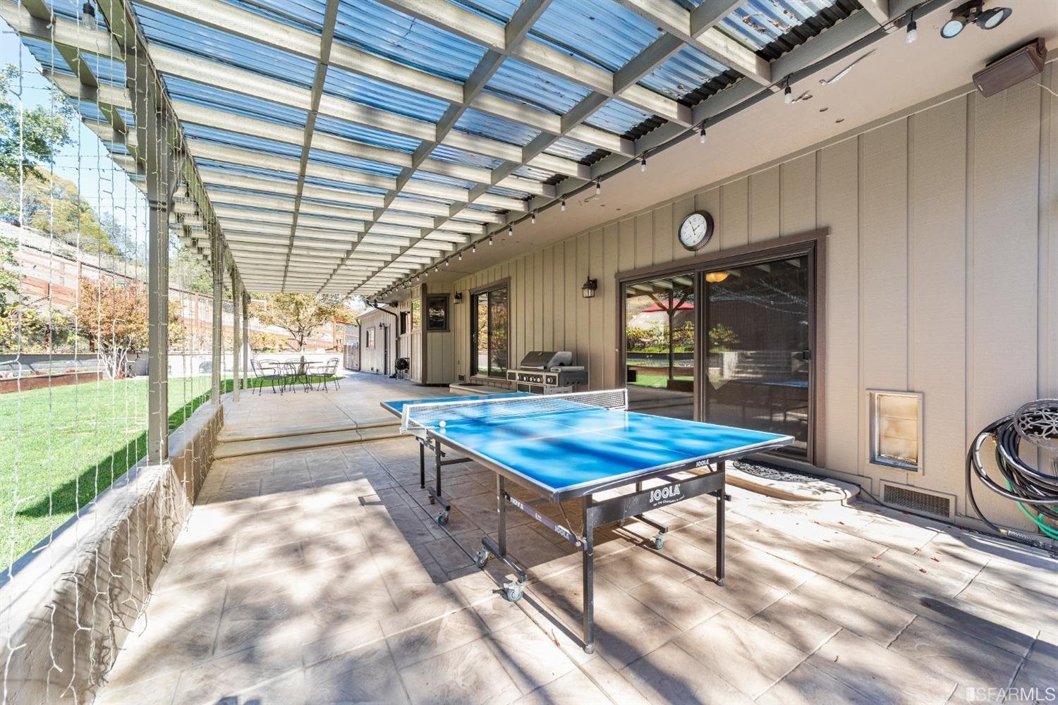 4912 John Muir Road Martinez, CA 94553 - Photo 50 of 59 a living room with a table tennis table and chairs