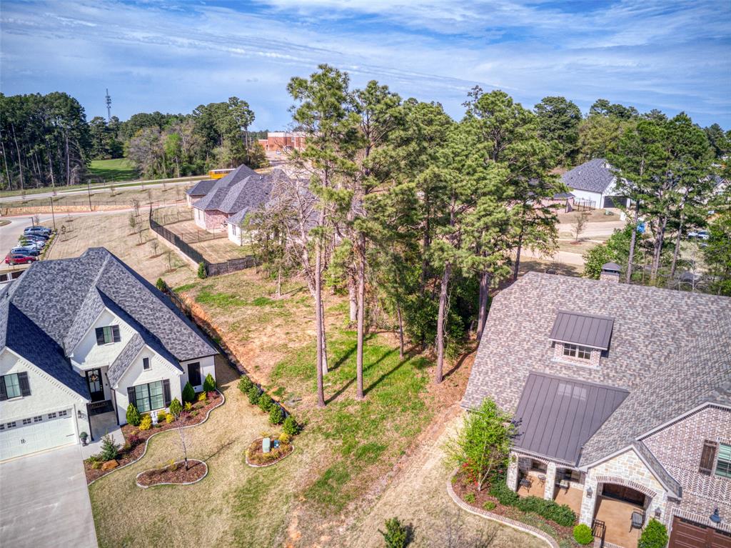 an aerial view of a house with a yard basket ball court and outdoor seating