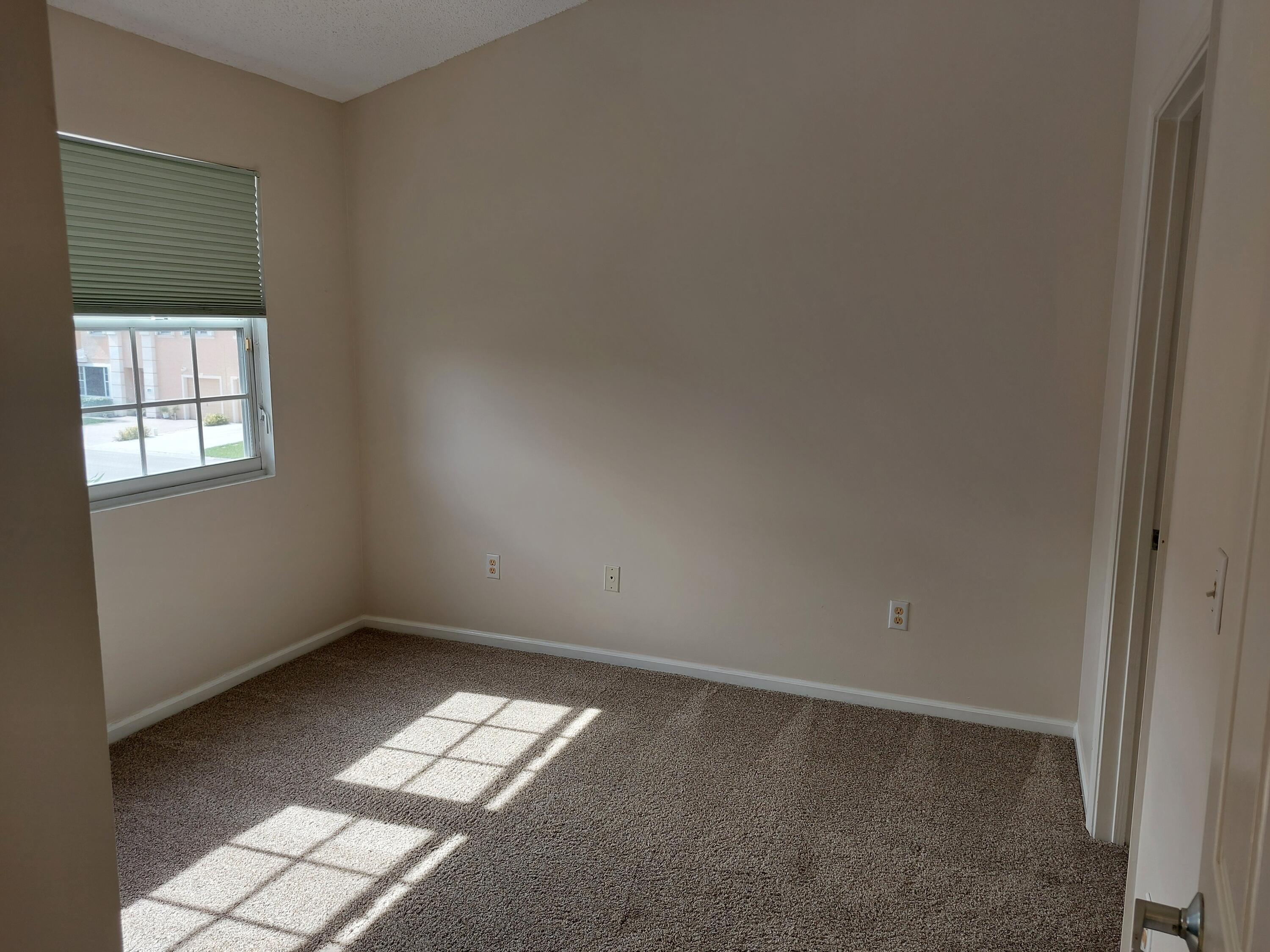 331 Oak Crest Terrace, Unit 331 Jupiter, FL 33458 - Photo 4 of 29 an empty room with windows