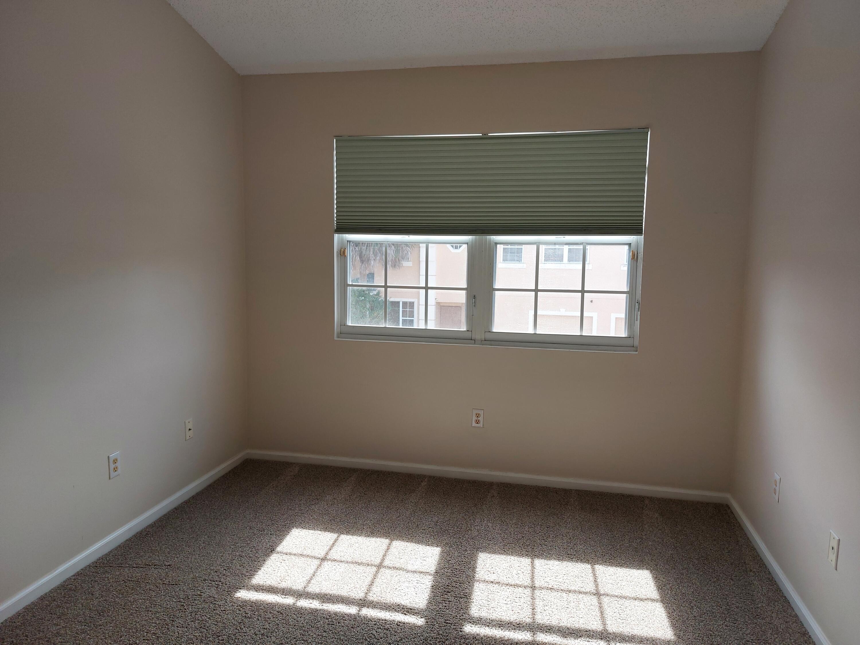 331 Oak Crest Terrace, Unit 331 Jupiter, FL 33458 - Photo 7 of 29 an empty room with a window