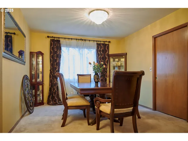a view of a dining room with furniture and a chandelier