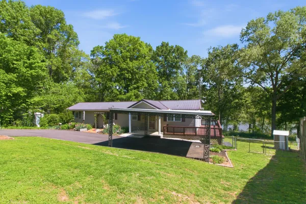 a view of a house with a yard patio and swimming pool