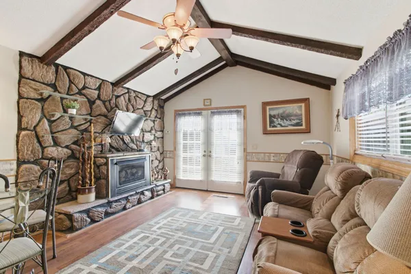 a living room with furniture a flat screen tv and a window