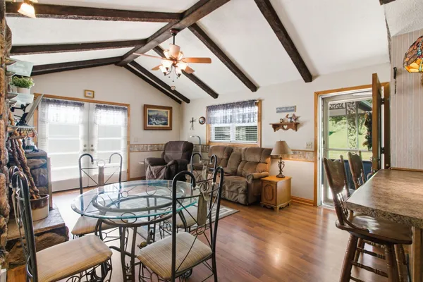 a dining room with furniture and wooden floor