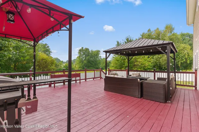 a bedroom with a large bed a chandelier and a window
