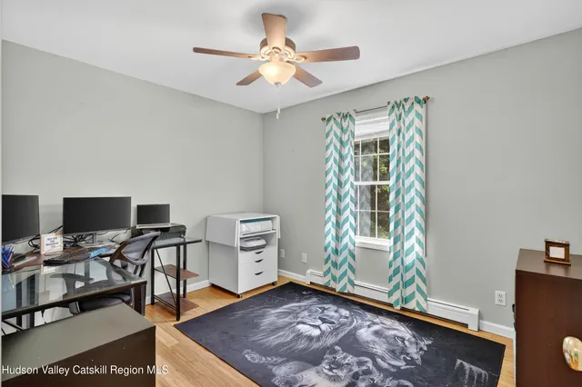a bedroom with furniture and a wooden floor