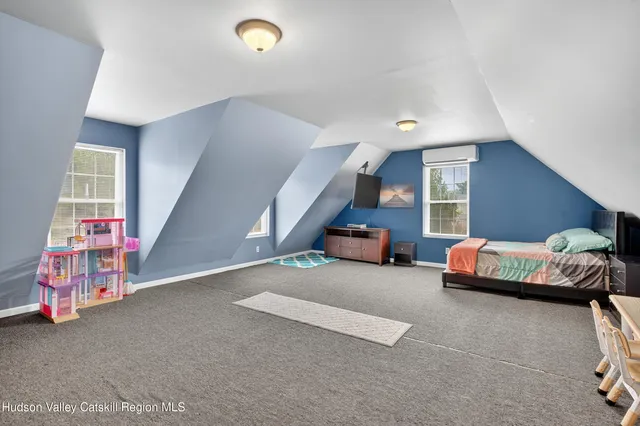 a living room with stainless steel appliances lots of furniture and kitchen view