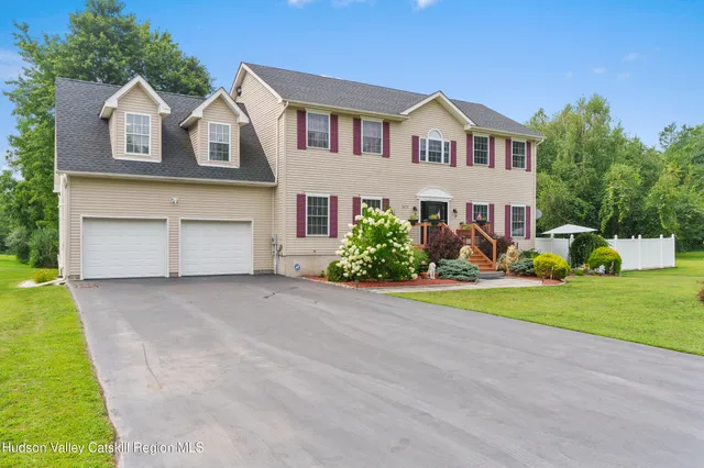 a front view of house with yard and green space