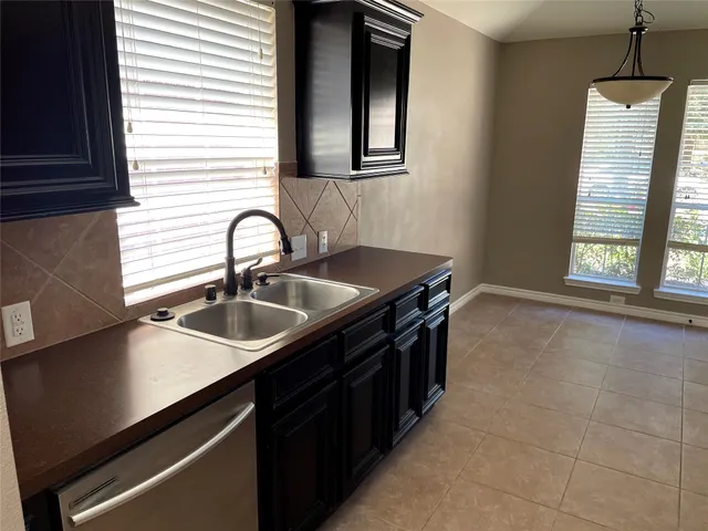 a kitchen with a sink and cabinets