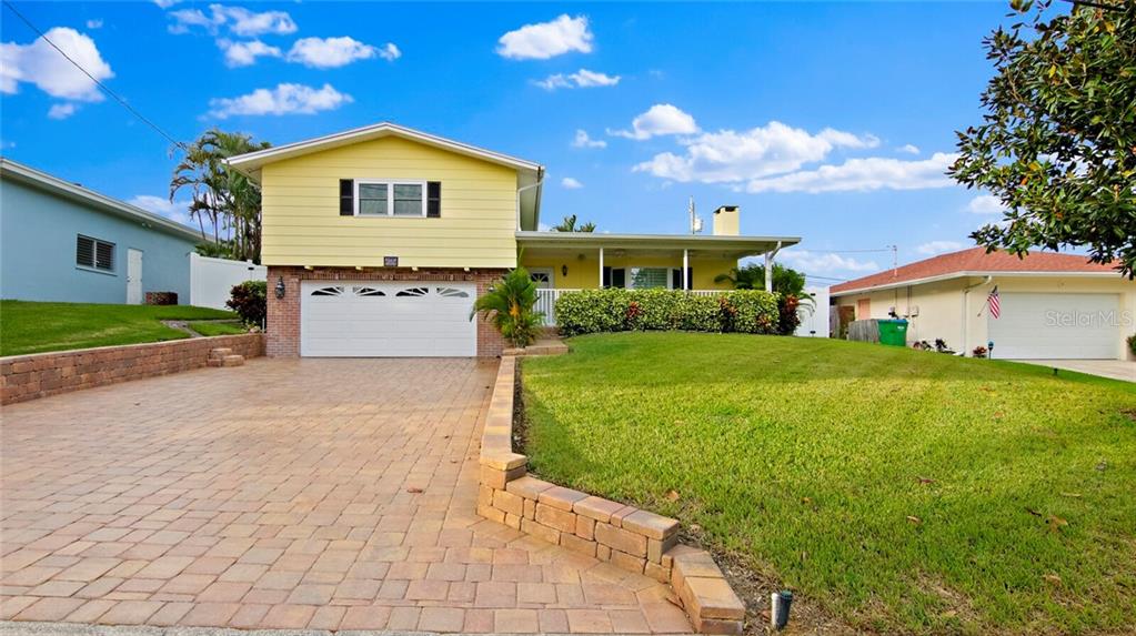 3557 Avocado Road Largo, FL 33770 - Photo 1 of 1 Front view of house with large lanai and oversized 2-car garage