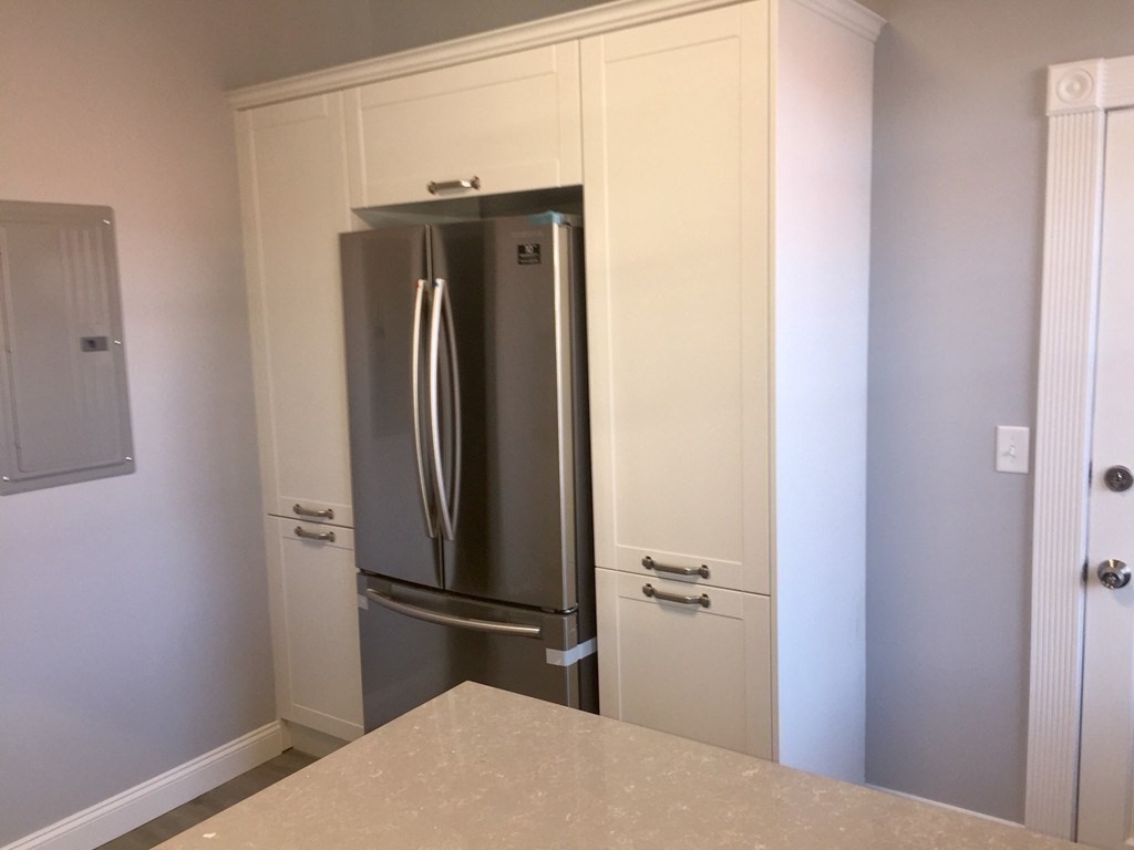 7 Leicester Street, Unit 2 Boston, MA 02135 - Photo 3 of 9 a bathroom with a sink and a refrigerator