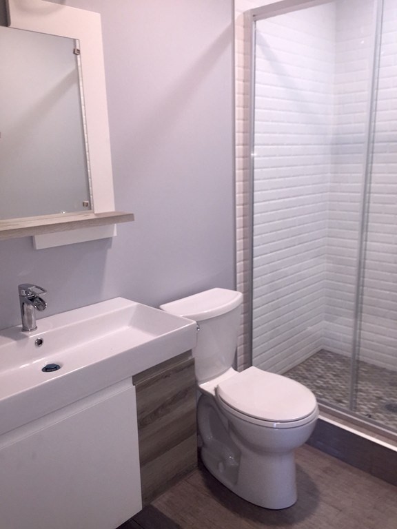 7 Leicester Street, Unit 2 Boston, MA 02135 - Photo 6 of 9 a bathroom with a sink a toilet and shower